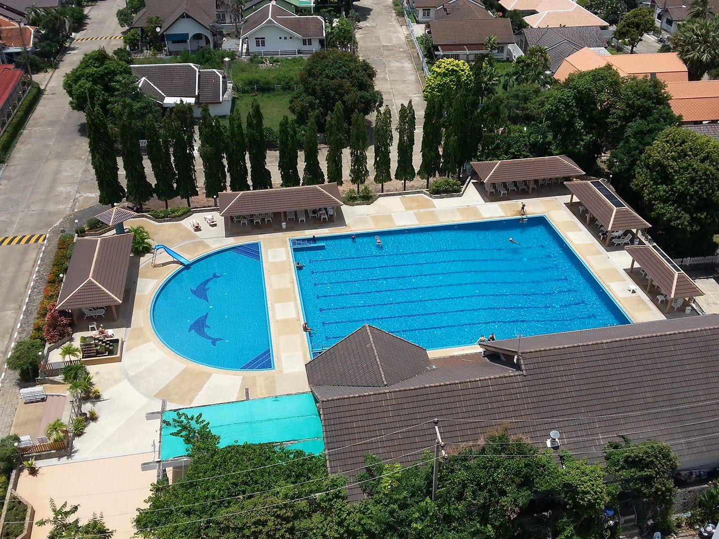Aerial view of the complex: the large swimming pool, the children's pool with slide, the pool restaurant and the village houses